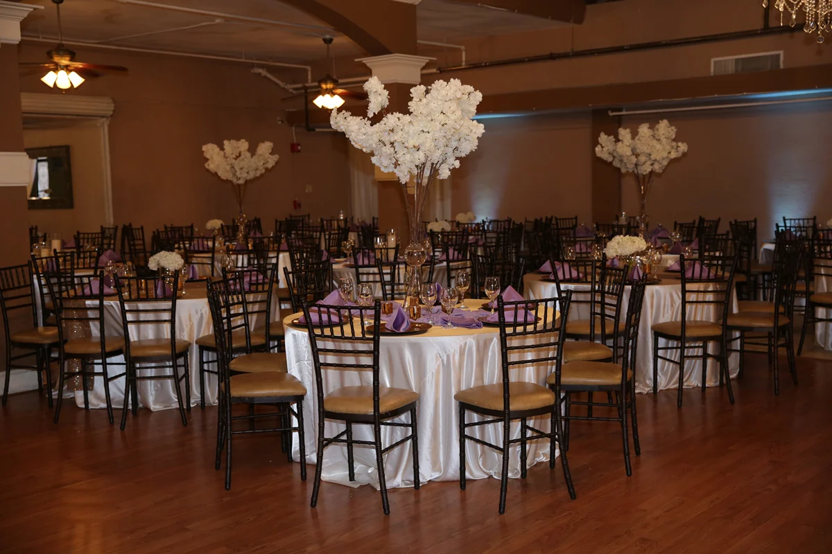 Elegant round banquet tables with floral arrangements and Chiavari chairs