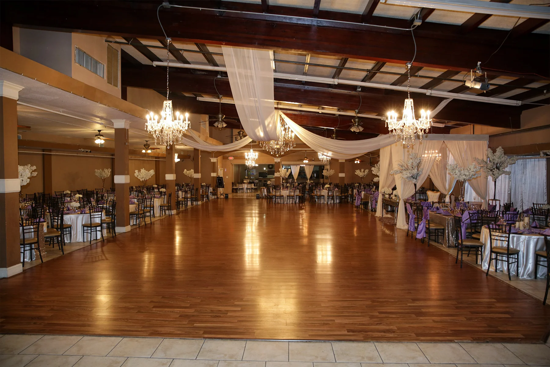 Selebracion Ballroom's spacious hardwood dance floor, crystal chandeliers and elegant banquet seating